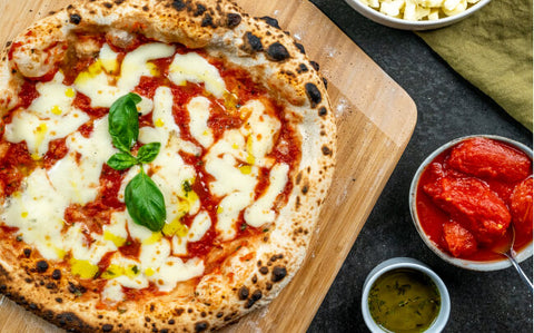 Pizza on a table with groceries